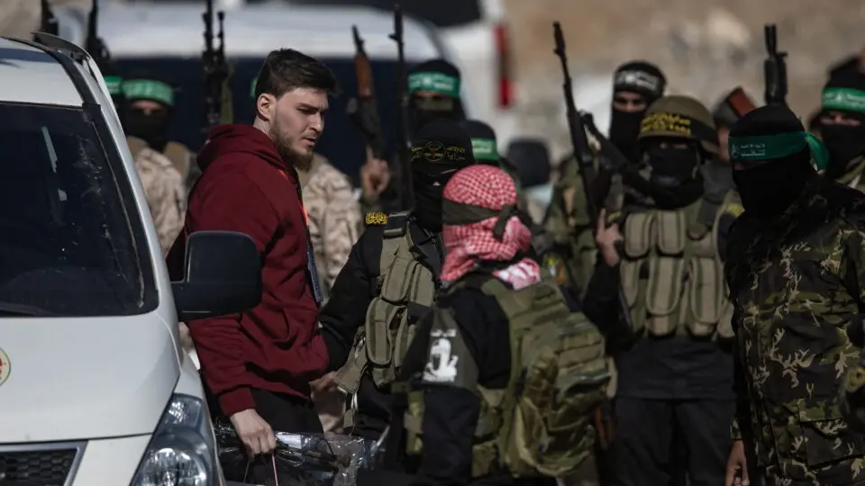 Membros do Hamas e da Jihad Islâmica escoltam o refém russo-israelense Sasha (Alexander) Troufanov antes de entregá-lo à equipe da Cruz Vermelha, em Khan Yunis, sul da Faixa de Gaza, 15 de fevereiro de 2025. Crédito: EFE