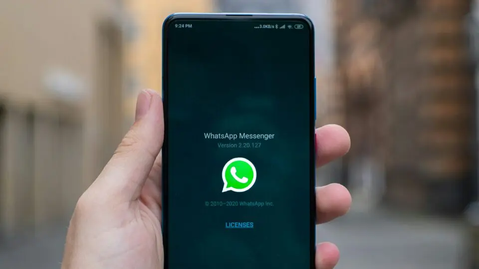 Homem segurando o celular com a página do WhatsApp IA aberto. 