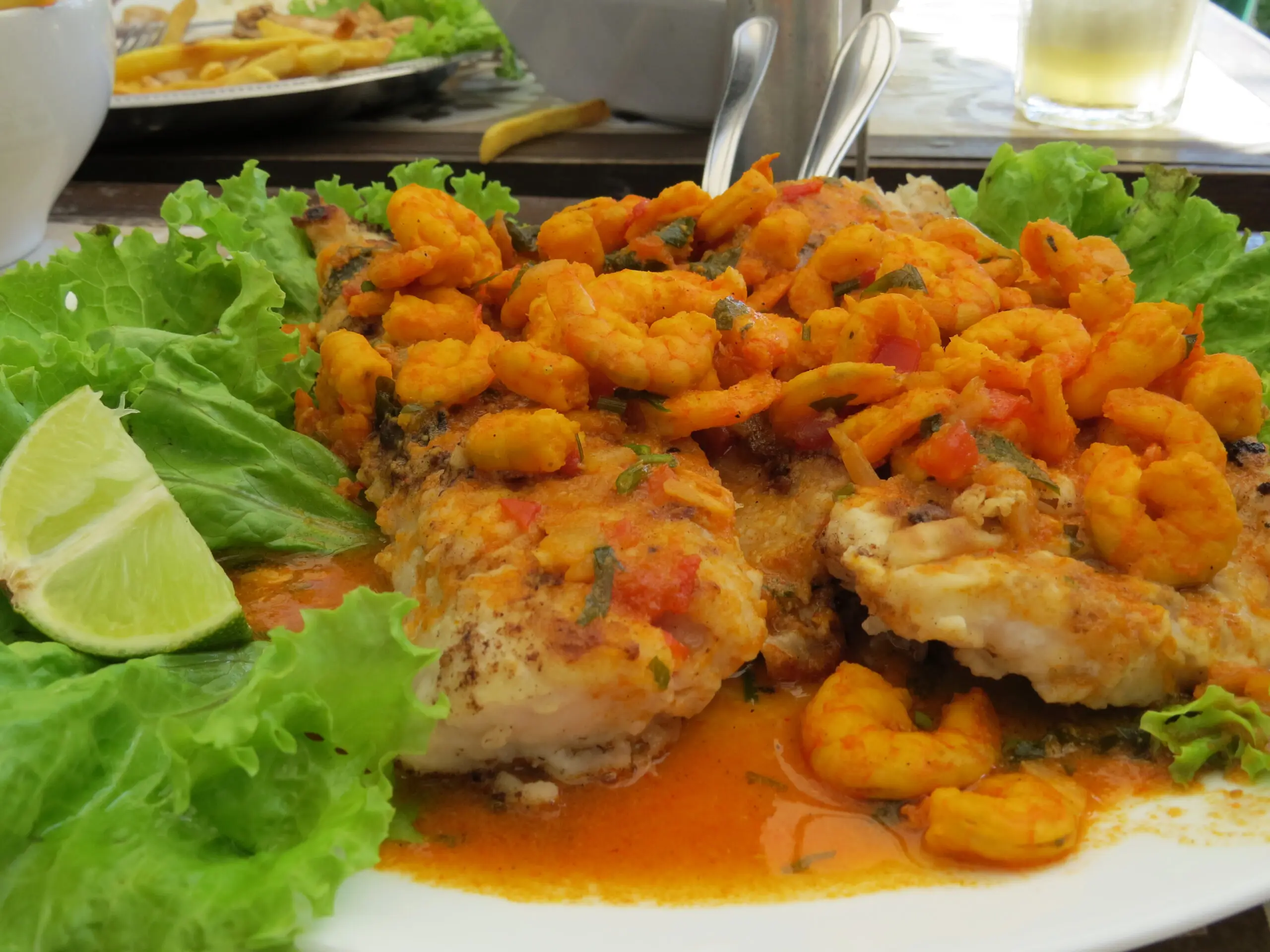 Peixe ao molho de camarão, prato tradicional servido nas praias de Florianópolis.