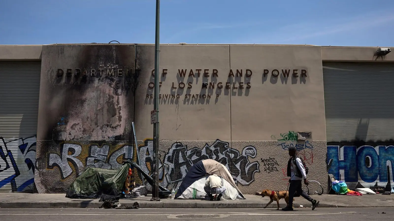 Moradores de rua ocupam a calçada em frente a prédio dilapidado em Los Angeles, na Califórnia: os bons tempos ficaram no passado.