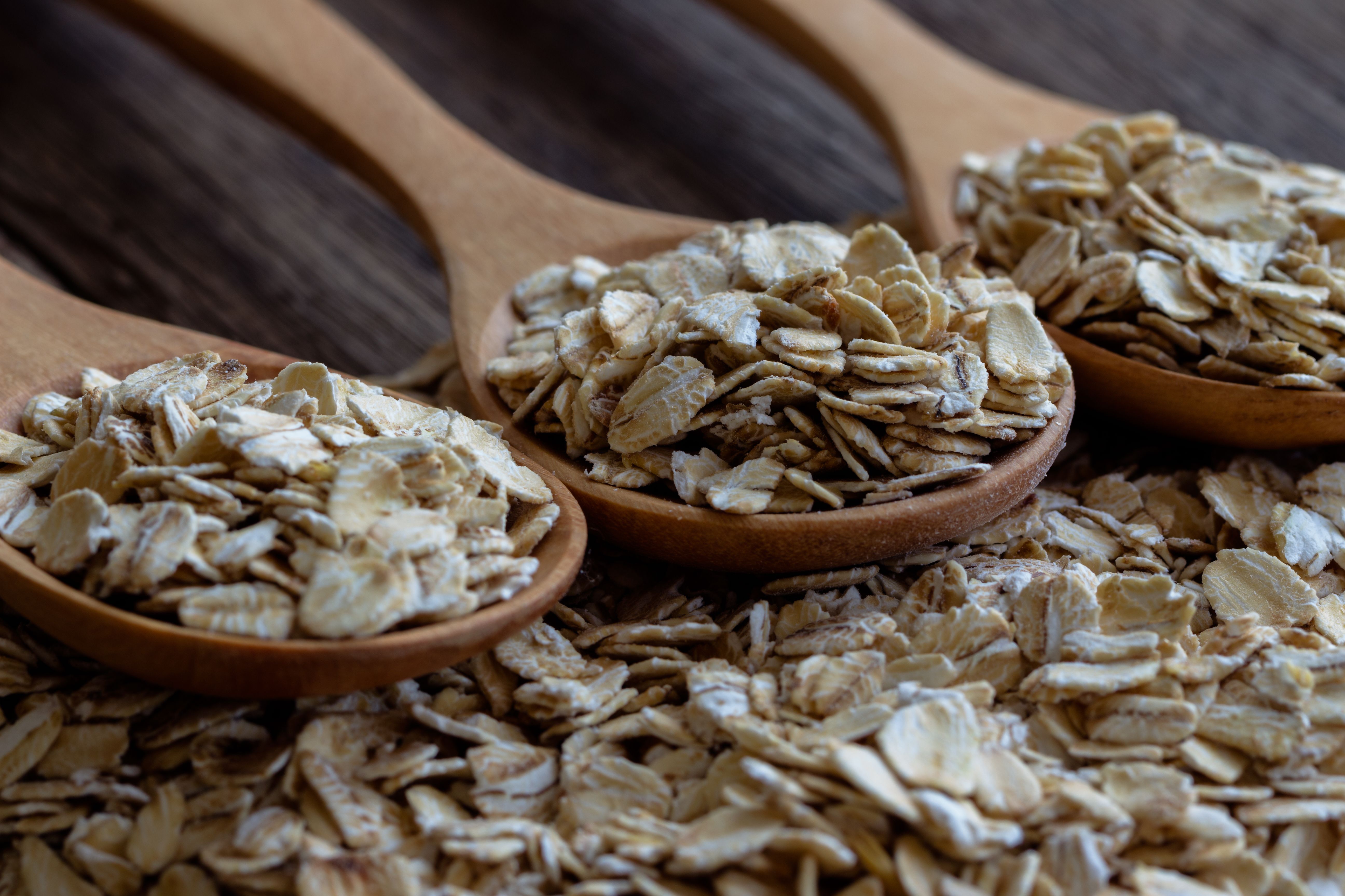 Oat flakes or oatmeal in wood spoon on rustic wood table. Rolled oat is clean food for health lover people. Prepare oat flakes for bakery or cooking.Natural organic food in vintage style concept.Oat flake, oatmeal background and texture. Oat flakes or oatmeal in wood spoon on rustic wood table. Rolled oat is clean food for health lover people. Prepare oat flakes for bakery or cooking.Natural organic food in vintage style concept.Oat flake, oatmeal background and texture.