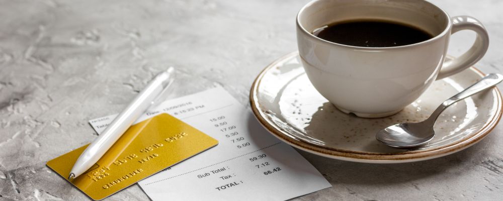 restaurant bill, credit card and coffee on stone table background