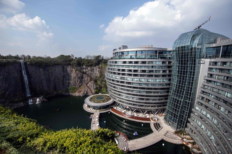 TOPSHOT - This picture taken on November 13, 2018 shows the InterContinental Shanghai Wonderland, built inside a formerly abandoned quarry, about 32 kms (20 miles) southwest of Shanghai. - Engineers faced unique challenges and guests will need deep pockets, but the hotel built into a disused Shanghai quarry opened on November 15 as part of a 288 million USD development. (Photo by Johannes EISELE / AFP) TOPSHOT - This picture taken on November 13, 2018 shows the InterContinental Shanghai Wonderland, built inside a formerly abandoned quarry, about 32 kms (20 miles) southwest of Shanghai. - Engineers faced unique challenges and guests will need deep pockets, but the hotel built into a disused Shanghai quarry opened on November 15 as part of a 288 million USD development. (Photo by Johannes EISELE / AFP)