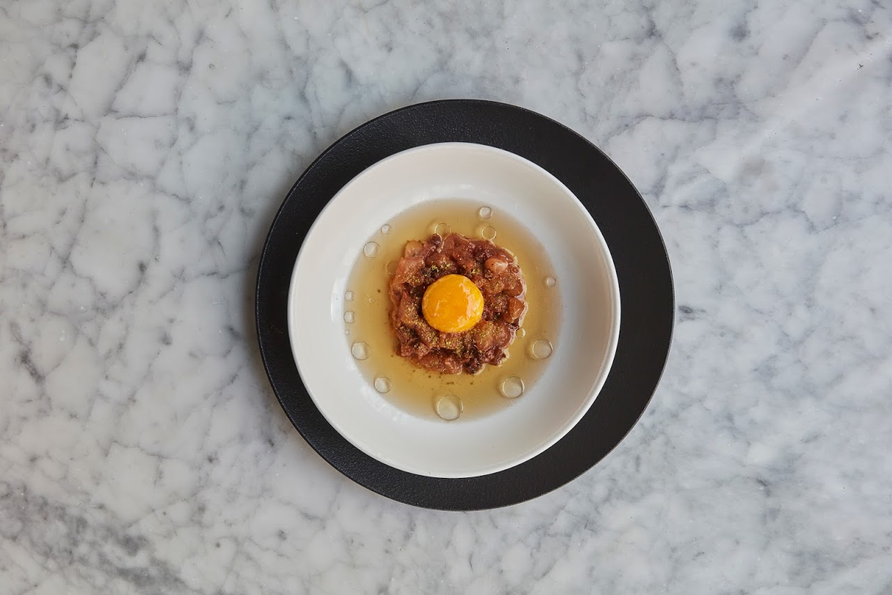 Tartar de pescado, caldo de carne e gema de ovo, prato do restaurante Ambrosía. Foto: Divulgação Tartar de pescado, caldo de carne e gema de ovo, prato do restaurante Ambrosía. Foto: Divulgação