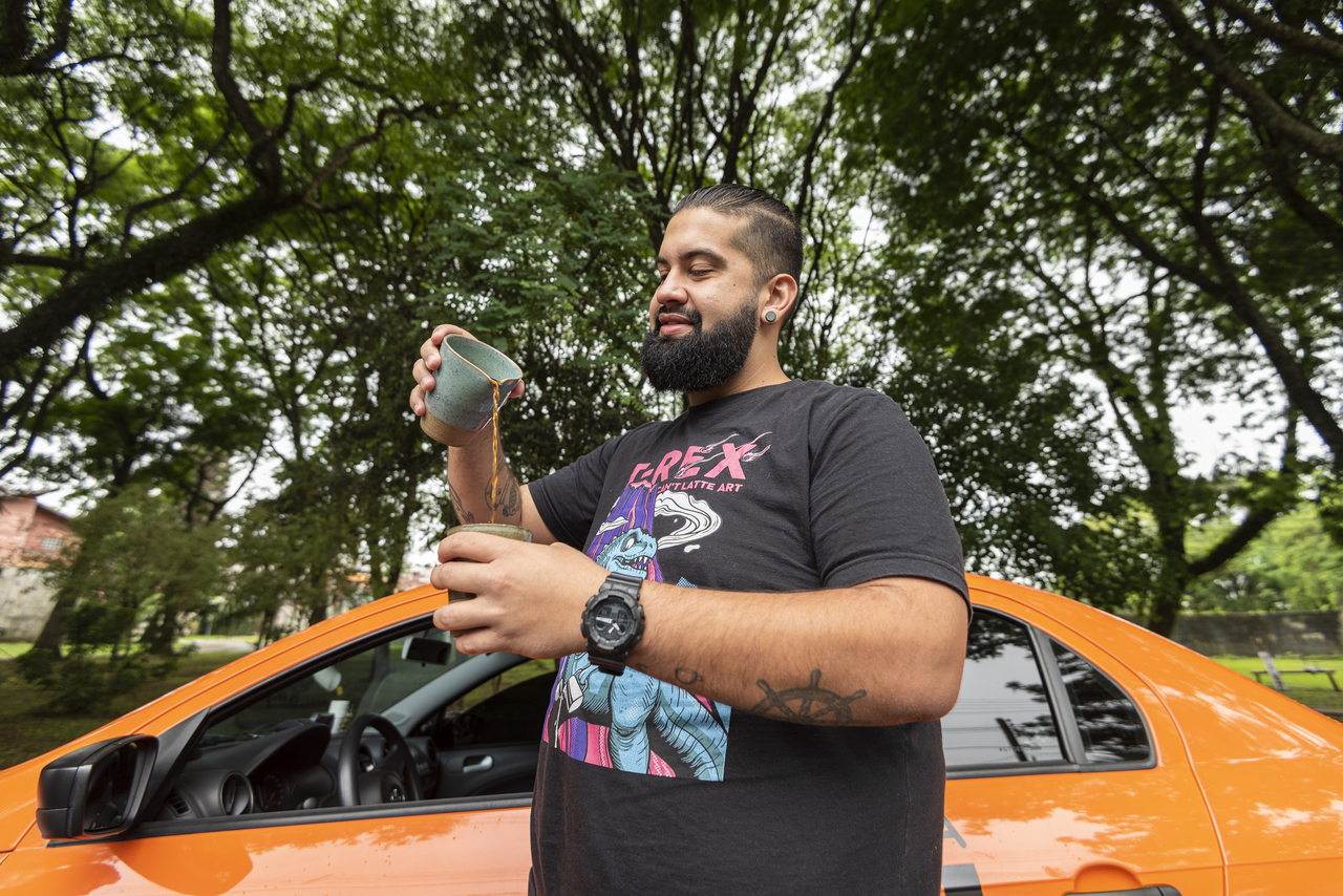 Caio Bohrer, taxista há quatro anos, passa café na hora para os passageiros. Foto: Fernando Zequinão/Gazeta do Povo Caio Bohrer, taxista há quatro anos, passa café na hora para os passageiros. Foto: Fernando Zequinão/Gazeta do Povo