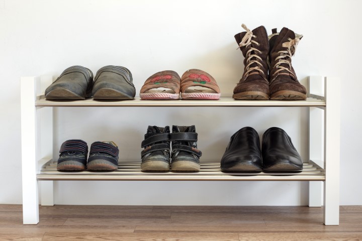 Six pairs of shoes on a shelf in the hallway in the house for the whole family: dad's mama's and child. Six pairs of shoes on a shelf in the hallway in the house for the whole family: dad's mama's and child.