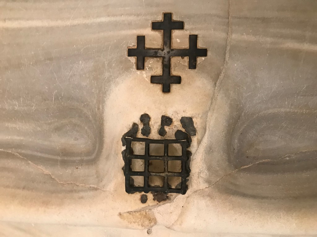 A medieval cross and grate set into the marble staircase which Catholic tradition holds Jesus climbed at his judgment before the Roman prefect Pontius Pilate, in Rome, April 8, 2019. The steps, now in a sanctuary across from the Basilica of St. John Lateran, were purportedly brought to Rome in 326 A.D.; the grate covers a spot said to be stained by a drop of Christ's blood. (Elisabetta Povoledo/The New York Times) A medieval cross and grate set into the marble staircase which Catholic tradition holds Jesus climbed at his judgment before the Roman prefect Pontius Pilate, in Rome, April 8, 2019. The steps, now in a sanctuary across from the Basilica of St. John Lateran, were purportedly brought to Rome in 326 A.D.; the grate covers a spot said to be stained by a drop of Christ's blood. (Elisabetta Povoledo/The New York Times)