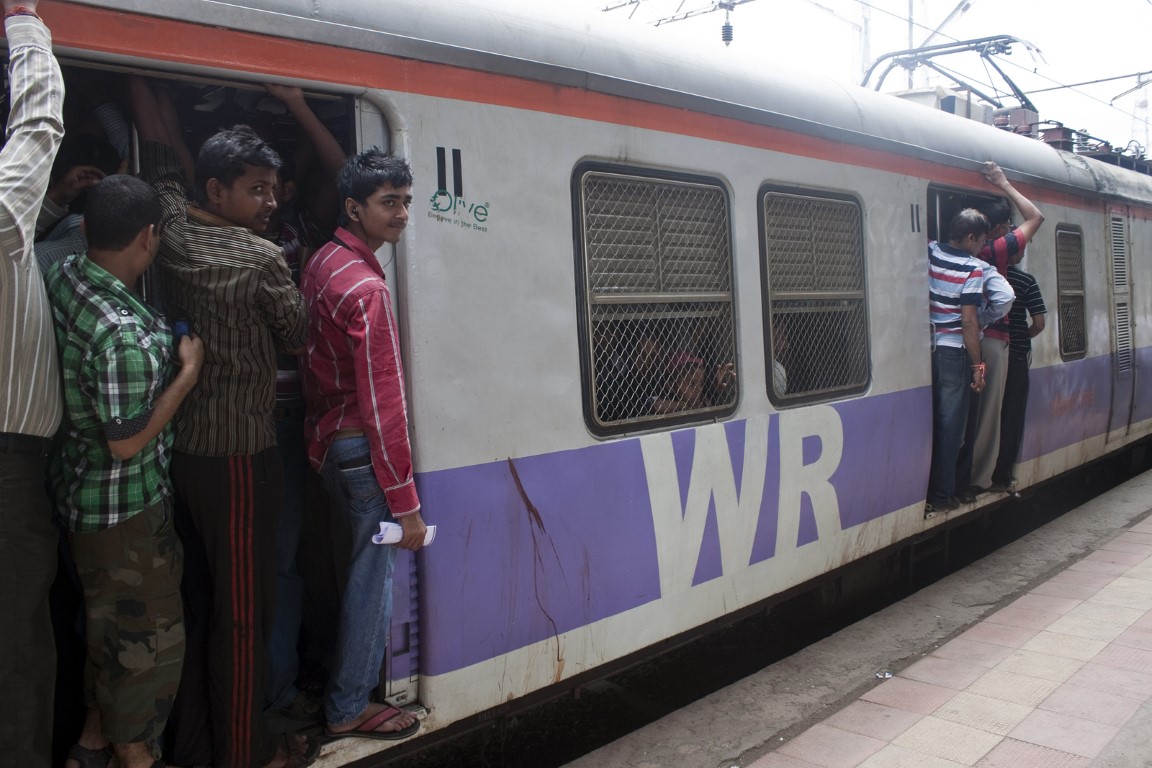 MUMBAI, INDIA - AUGUST 21: Commuting by train on August 21, 2011 in Mumbai, India. Mumbai Suburban Railway carries more than 7 million commuters on a daily basis. MUMBAI, INDIA - AUGUST 21: Commuting by train on August 21, 2011 in Mumbai, India. Mumbai Suburban Railway carries more than 7 million commuters on a daily basis.