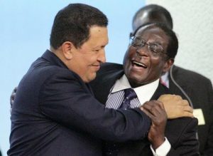 (FILES) This photo taken October 17, 2005 shows Venezuelan President Hugo Chavez (L) hugging Zimbabwe's President Robert Mugabe (R) after Mugabe's speech during a hunger conference to mark the 60th anniversary of the United Nation's Food and Agriculture Organisation at Rome's FAO headquarters. An official in Mugabe's ZANU-PF party said April 1, 2008 that Mugabe, who has ruled the former British colony since independence in 1980, is ready to step down after he accepted he failed to win the country's presidential election. The 84-year-old Mugabe, Africa's oldest leader, has blamed the economic woes on the European Union and the United States, which imposed sanctions on his inner circle after he was accused of rigging his 2002 re-election. AFP PHOTO / GIULIO NAPOLITANO (Photo credit should read GIULIO NAPOLITANO/AFP/Getty Images)