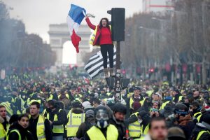A protester wearing yellow vest, a symbol of a French drivers' protest against higher fuel prices, stands on the red light on the Champs-Elysee in Paris, France, November 24, 2018. REUTERS/Benoit Tessier TPX IMAGES OF THE DAY