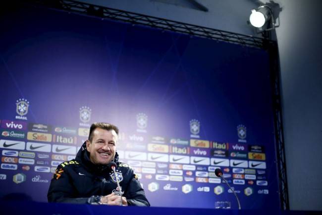 Brazil's head coach Dunga listens to a question during a news conference before his team's training session at Santiago