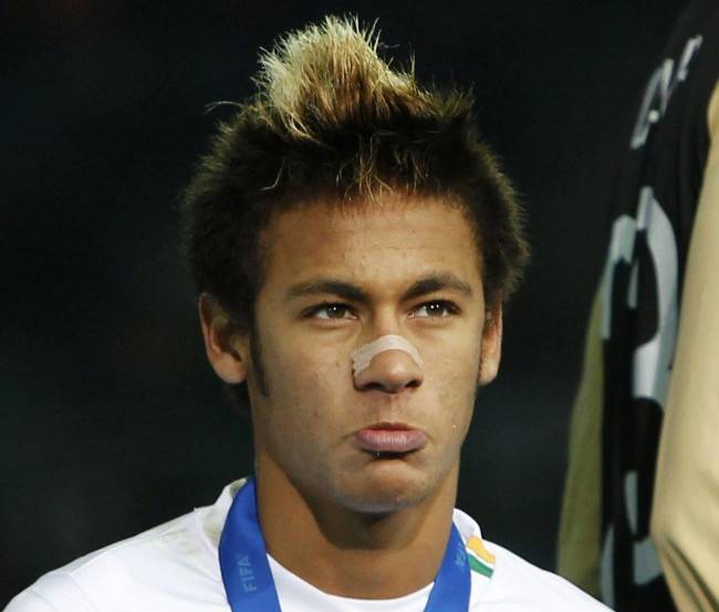 Neymar of Brazil's Santos reacts with his silver medal after losing their Club World Cup final soccer match against Spain's Barcelona in Yokohama