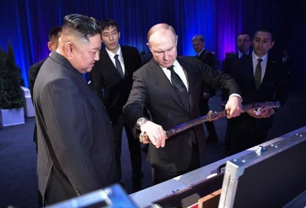 O presidente russo Vladimir Putin observa uma espada que ganhou de presente do ditador da Coreia do Norte, Kim Jong-un, no primeiro encontro entre os dois. Foto: Alexey NIKOLSKY / SPUTNIK / AFP